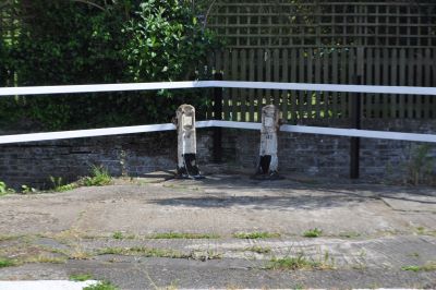 Side pont baddles beside lock but brick wall and garden behind